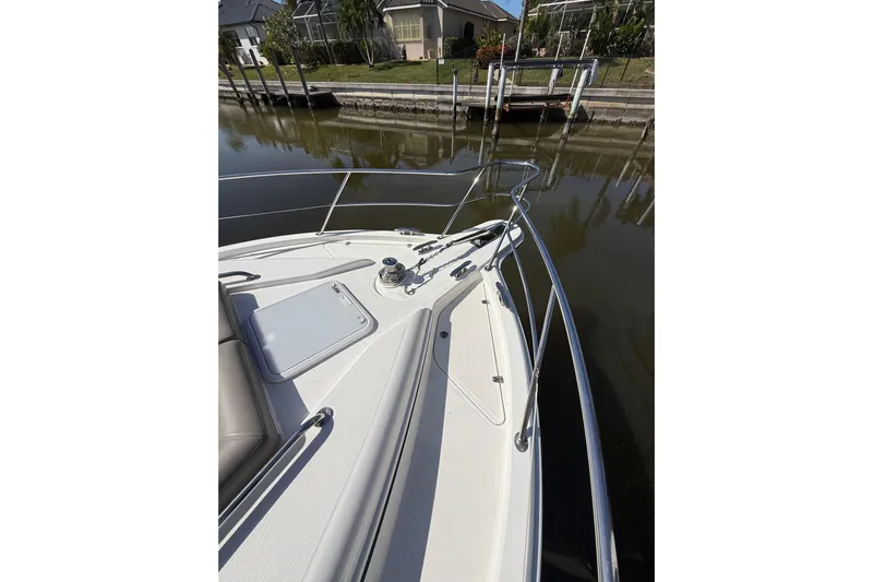  Yacht Photos Pics Bow of 2021 Riviera 395 SUV yacht docked by a canal.