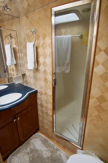 Grape Escape Yacht Photos Pics Bathroom interior of 2000 Hatteras 60 Convertible yacht with shower and vanity.