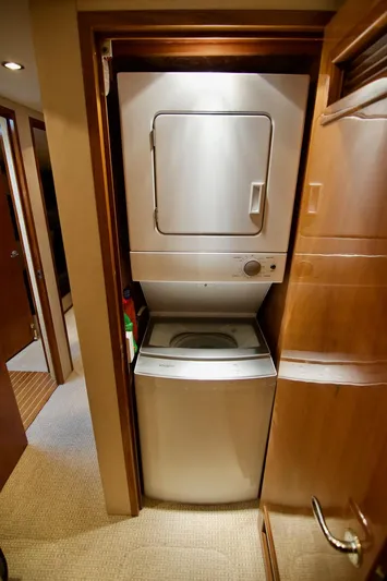 Grape Escape Yacht Photos Pics Stacked washer and dryer in 2000 Hatteras 60 Convertible yacht interior.