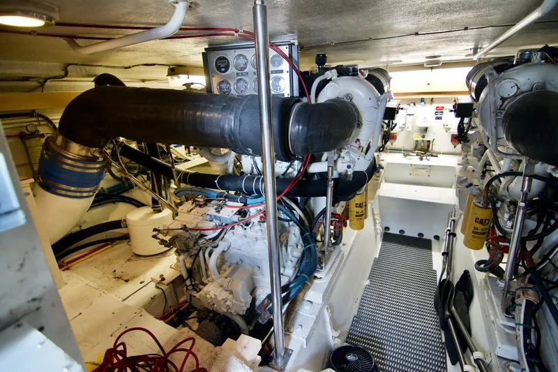 Grape Escape Yacht Photos Pics Engine room of 2000 Hatteras 60 Convertible yacht, featuring dual engines and mechanical components.