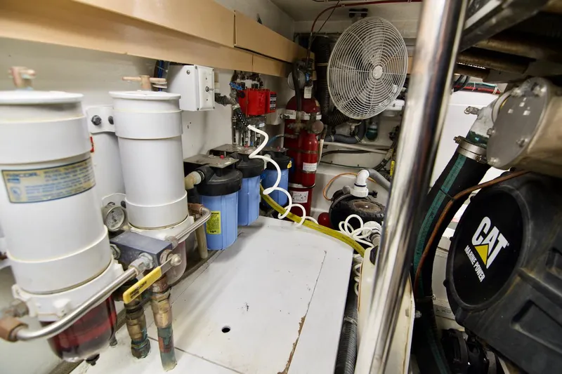 Grape Escape Yacht Photos Pics Engine room of 2000 Hatteras 60 Convertible yacht with CAT machinery and filtration systems.