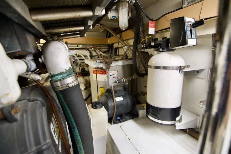 Grape Escape Yacht Photos Pics Engine room of 2000 Hatteras 60 Convertible yacht, showcasing mechanical components and equipment.