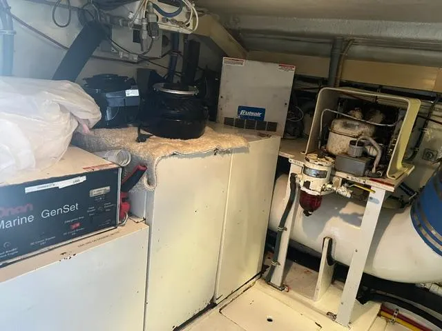 Grape Escape Yacht Photos Pics Engine room of 2000 Hatteras 60 Convertible with marine generator and equipment.