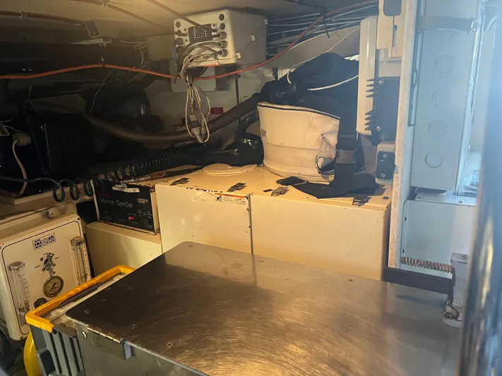 Grape Escape Yacht Photos Pics Engine room of 2000 Hatteras 60 Convertible yacht with equipment and storage.