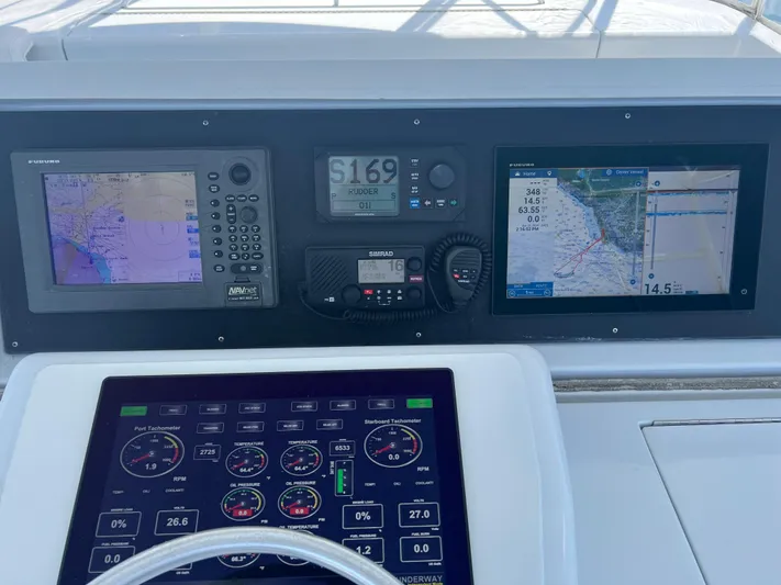 Grape Escape Yacht Photos Pics Control panel of a 2000 Hatteras 60 Convertible yacht with navigation displays.