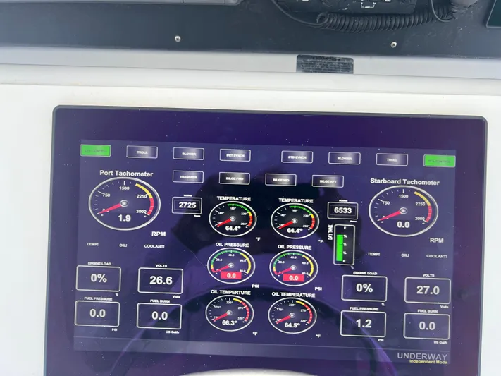 Grape Escape Yacht Photos Pics Control panel of a 2000 Hatteras 60 Convertible yacht displaying engine metrics.