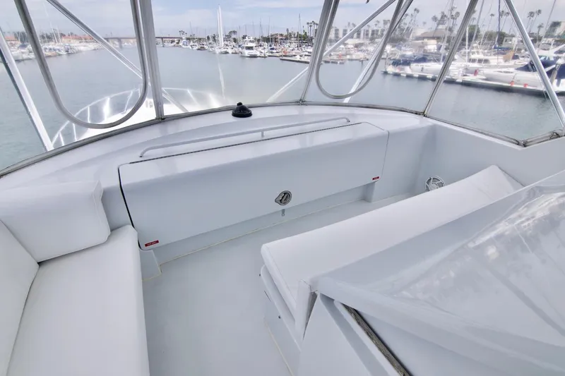 Grape Escape Yacht Photos Pics 2000 Hatteras 60 Convertible yacht interior with white seating, overlooking marina.