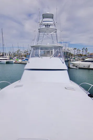 Grape Escape Yacht Photos Pics 2000 Hatteras 60 Convertible yacht docked in marina, showcasing sleek design and tower.