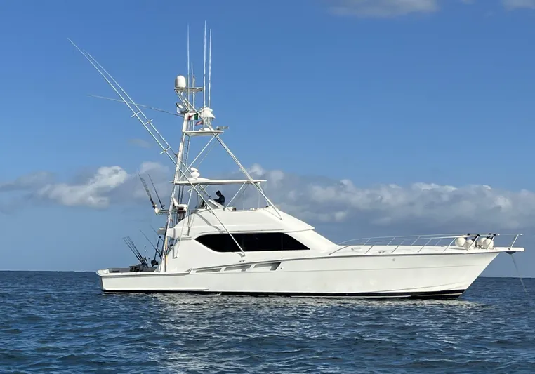 Grape Escape Yacht Photos Pics 2000 Hatteras 60 Convertible yacht on open water under clear blue sky.