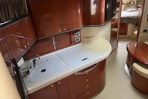  Yacht Photos Pics 2003 Sea Ray Sundancer 460 yacht interior with elegant wood cabinetry and modern kitchen amenities.