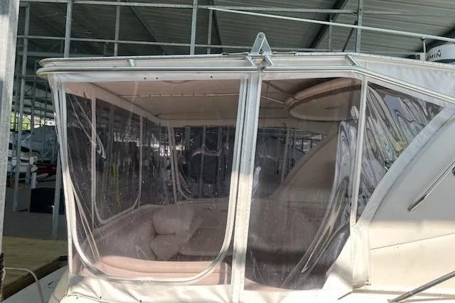  Yacht Photos Pics 2003 Sea Ray Sundancer 460 with enclosed cockpit under marina shelter.