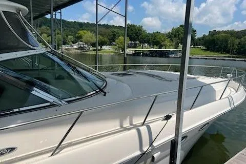  Yacht Photos Pics 2003 Sea Ray Sundancer 460 yacht docked by a scenic lakeside.