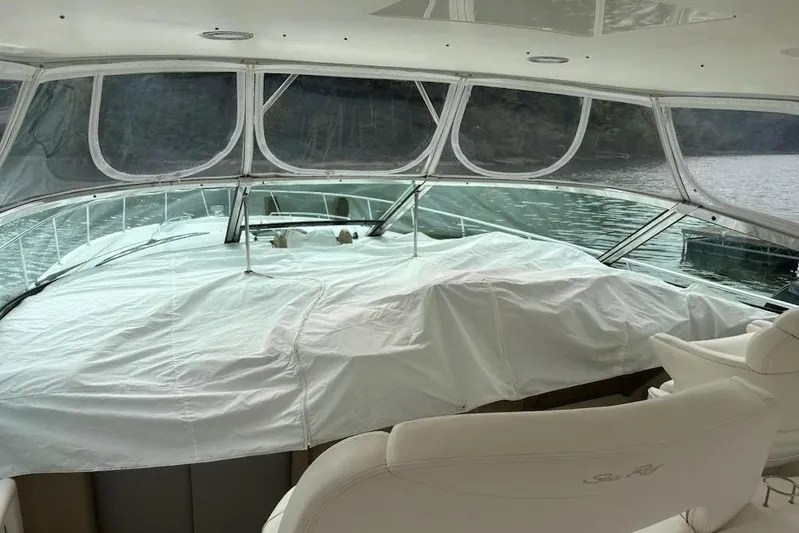  Yacht Photos Pics Interior view of 2003 Sea Ray Sundancer 460 yacht with covered deck and water backdrop.