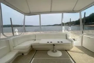  Yacht Photos Pics 2003 Sea Ray Sundancer 460 yacht interior with white seating and table, overlooking serene waters.