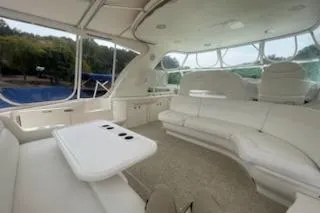  Yacht Photos Pics 2003 Sea Ray Sundancer 460 yacht interior with white seating and table, featuring large windows.