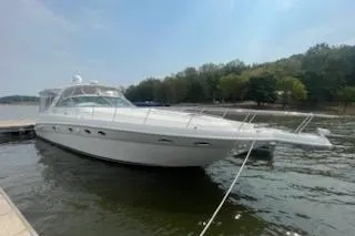  Yacht Photos Pics 2003 Sea Ray Sundancer 460 yacht docked on a calm lake with trees in the background.