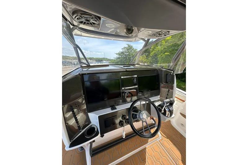  Yacht Photos Pics 2015 Nor-Tech 390 Sport Center Console dashboard with steering wheel and navigation controls.