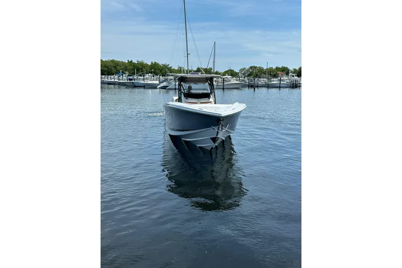  Yacht Photos Pics 2015 Nor-Tech 390 Sport Center Console boat on calm water, docked at marina.