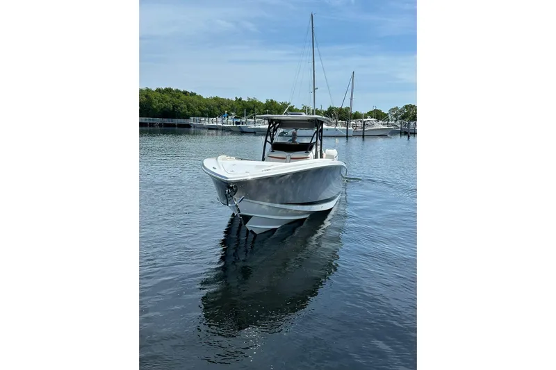  Yacht Photos Pics 2015 Nor-Tech 390 Sport Center Console boat on calm water, marina background.
