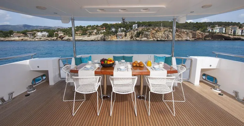 White Shark Yacht Photos Pics Luxury yacht dining area with ocean view, featuring a set table and modern chairs. Johnson 105, 2008.