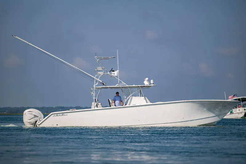  Yacht Photos Pics 2023 SeaHunter 46 CTS boat cruising on calm blue waters under clear skies.
