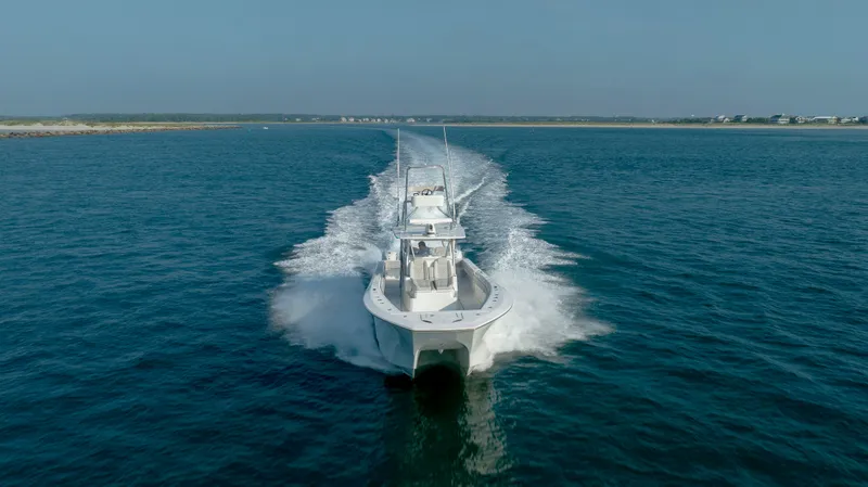 Yacht Photos Pics 2023 SeaHunter 46 CTS boat cruising on open water, creating a dynamic wake.