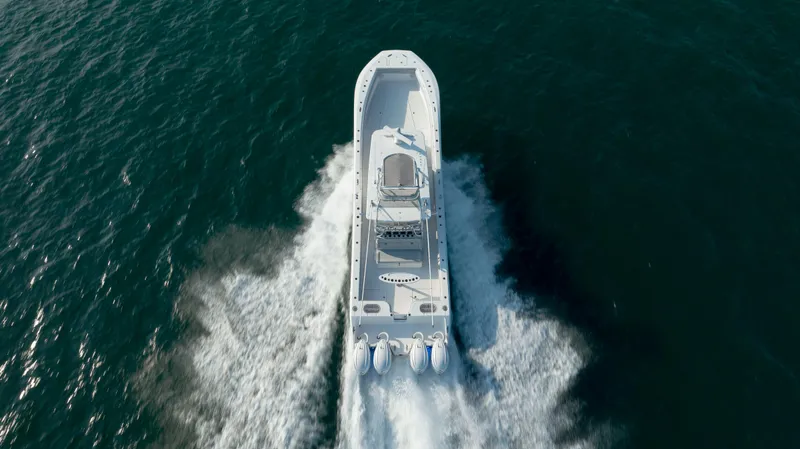  Yacht Photos Pics 2023 SeaHunter 46 CTS boat cruising on open water, aerial view.
