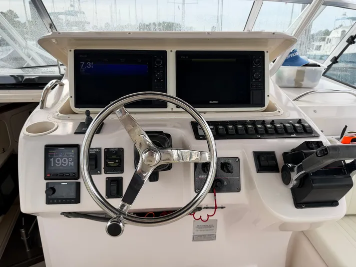Genau II Yacht Photos Pics Helm console of a 2004 Grady-White Express 330 boat.