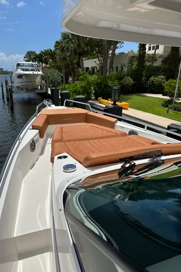 Special !! Call For Details! Yacht Photos Pics 2018 Axopar 370 SUN TOP boat with sun loungers docked by lush greenery.