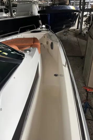 Special !! Call For Details! Yacht Photos Pics 2018 Axopar 370 SUN TOP boat in storage, showcasing sleek design and spacious deck.