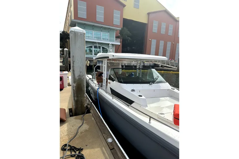 Special !! Call For Details! Yacht Photos Pics 2018 Axopar 370 SUN TOP boat docked near colorful buildings.