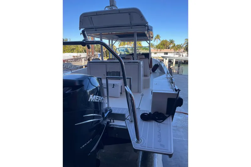 Special !! Call For Details! Yacht Photos Pics 2018 Axopar 370 SUN TOP boat with Mercury engine, docked near palm trees.