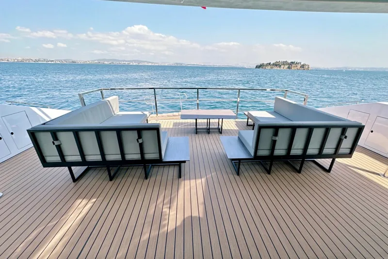  Yacht Photos Pics Luxurious 2023 Carboyacht 90 deck with modern seating, overlooking serene ocean view.