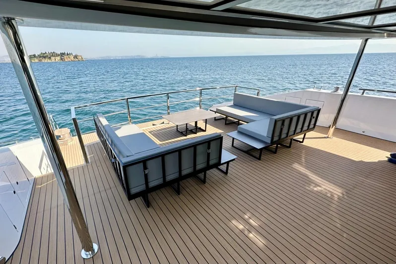  Yacht Photos Pics Luxurious 2023 Carboyacht 90 deck with modern seating, overlooking serene ocean view.