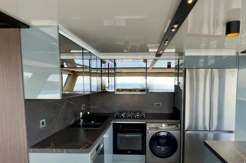  Yacht Photos Pics Modern kitchen interior on 2023 Carboyacht 90, featuring sleek appliances and ocean view.