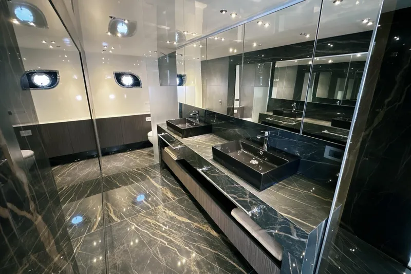  Yacht Photos Pics Luxurious bathroom in 2023 Carboyacht 90, featuring sleek black marble and modern fixtures.