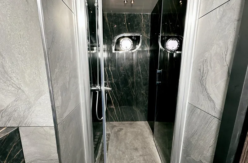  Yacht Photos Pics Luxurious bathroom in 2023 Carboyacht 90 with sleek marble design and modern fixtures.