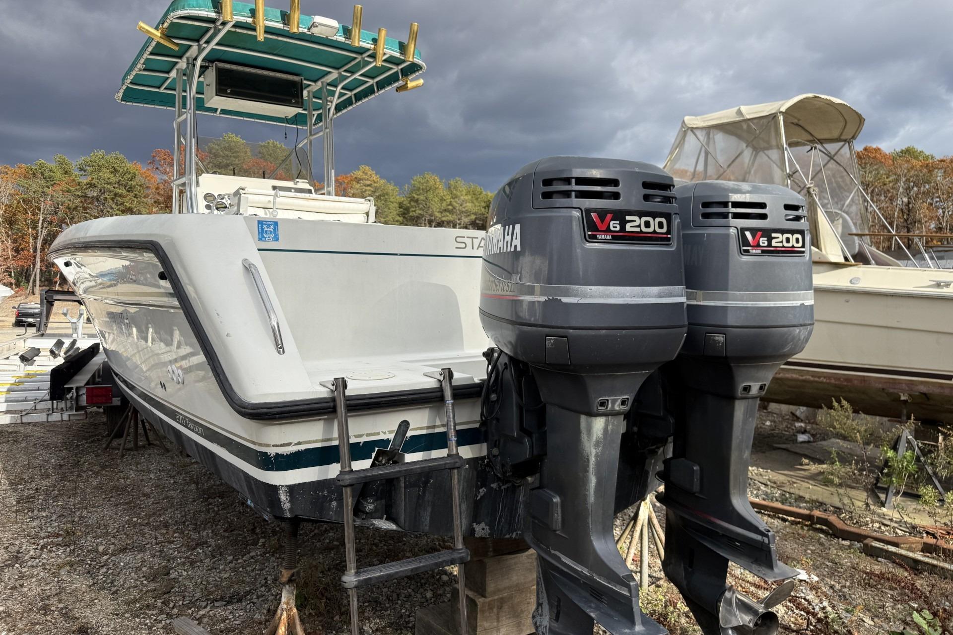 1997 Stamas 270 Tarpon boat with twin Yamaha V6 200 engines, docked outdoors.