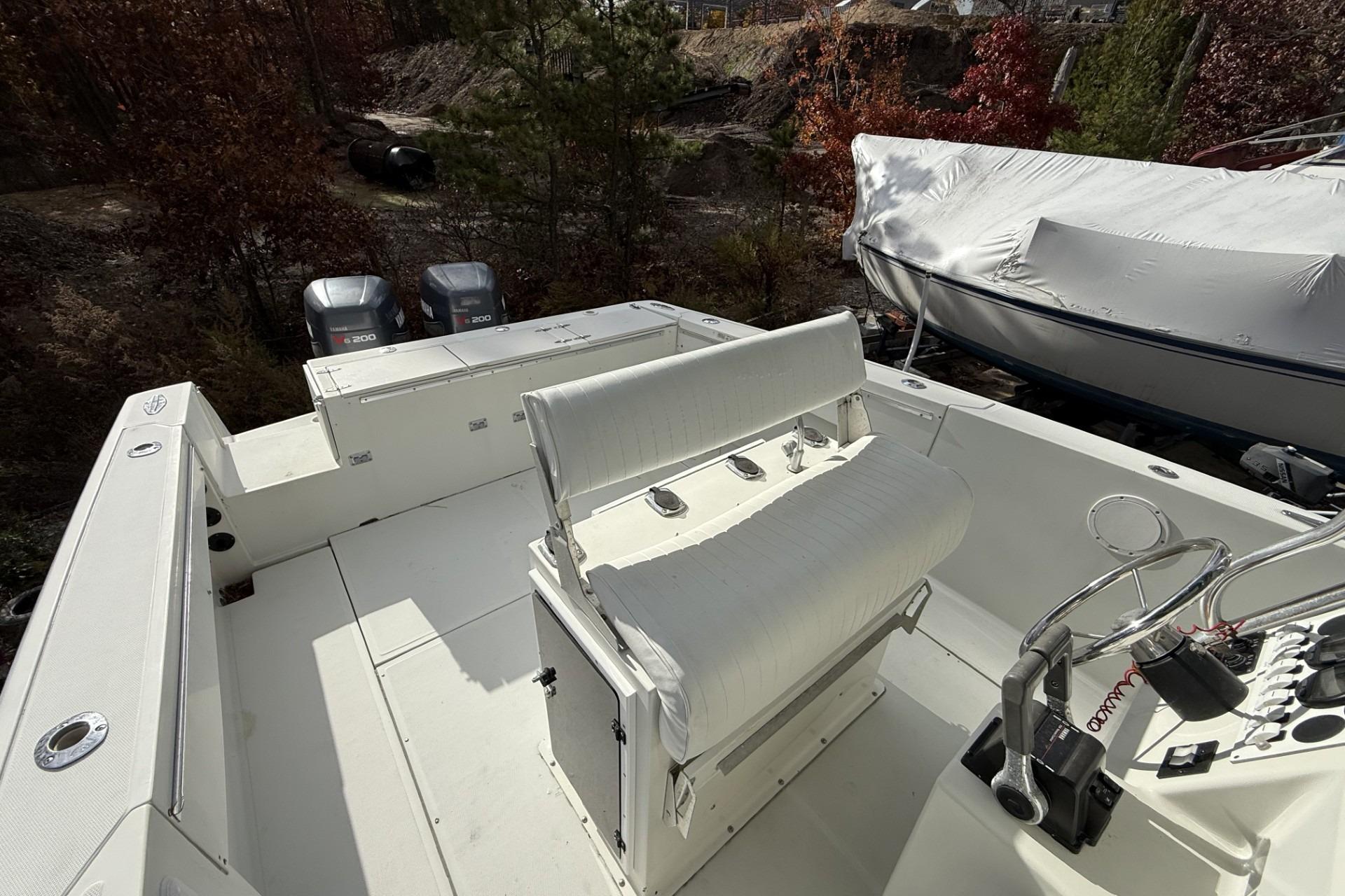 1997 Stamas 270 Tarpon boat interior with dual outboard motors and white seating.