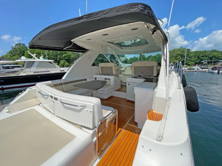  Yacht Photos Pics 2012 Sea Ray 450 Sundancer yacht with spacious deck and seating, docked in a marina.