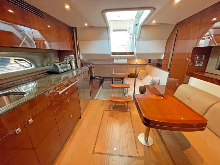  Yacht Photos Pics Luxurious interior of 2012 Sea Ray 450 Sundancer yacht with modern kitchen and seating area.