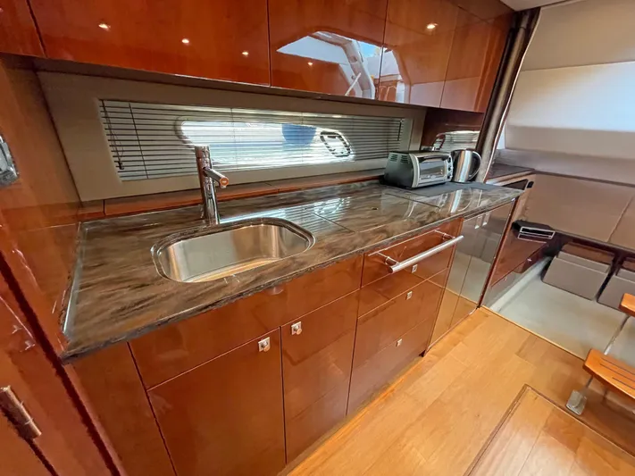  Yacht Photos Pics Luxurious kitchen interior of 2012 Sea Ray 450 Sundancer yacht with modern amenities.