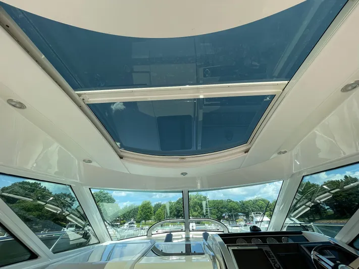  Yacht Photos Pics Interior view of 2012 Sea Ray 450 Sundancer yacht with sunroof and scenic background.