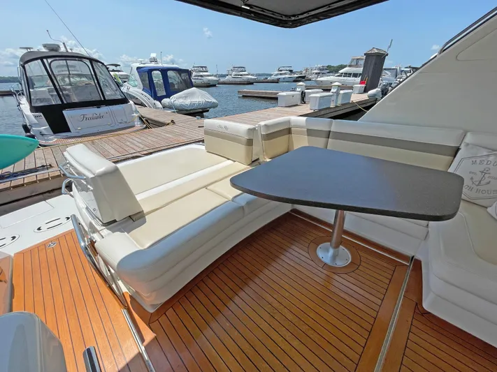  Yacht Photos Pics 2012 Sea Ray 450 Sundancer yacht with spacious deck and seating area at marina.