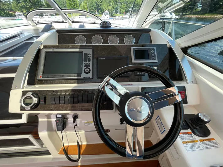  Yacht Photos Pics 2012 Sea Ray 450 Sundancer helm with modern navigation controls and steering wheel.