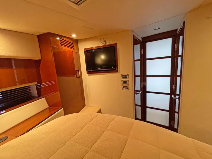  Yacht Photos Pics Luxurious cabin interior of 2012 Sea Ray 450 Sundancer yacht with TV and elegant wood finishes.