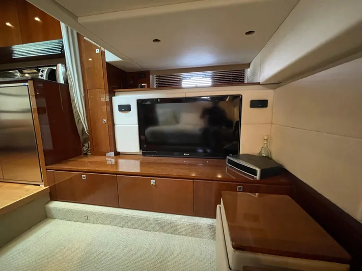  Yacht Photos Pics Luxurious interior of 2012 Sea Ray 450 Sundancer yacht with TV and wood cabinetry.