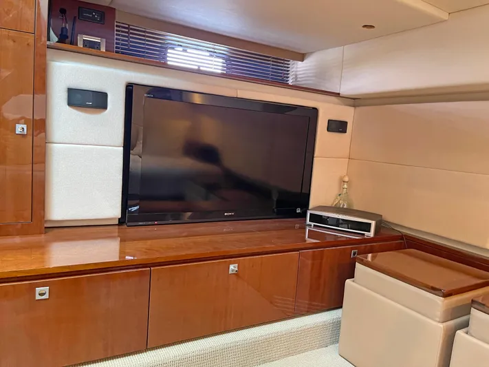  Yacht Photos Pics Luxurious interior of 2012 Sea Ray 450 Sundancer with TV and wooden cabinetry.