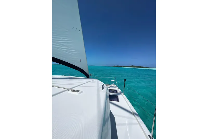  Yacht Photos Pics Sailing on a 2019 Leopard 45 catamaran in turquoise waters under a clear blue sky.