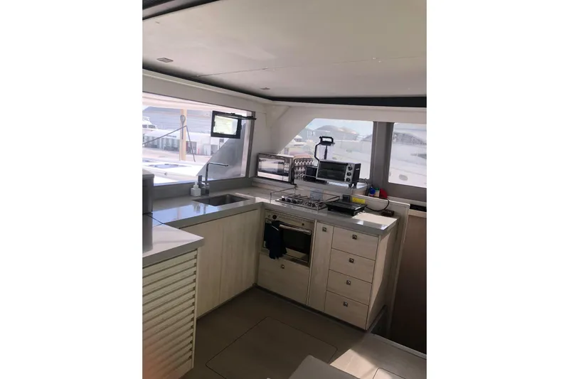  Yacht Photos Pics Modern kitchen interior on 2019 Leopard 45 yacht, featuring sleek countertops and appliances.